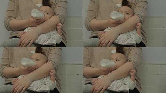 刚出生的婴儿吃奶瓶中的牛奶