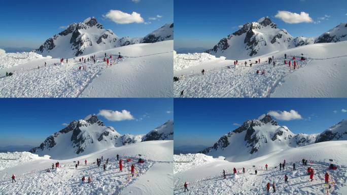航拍玉龙雪山脚下的游客蓝天白云白雪