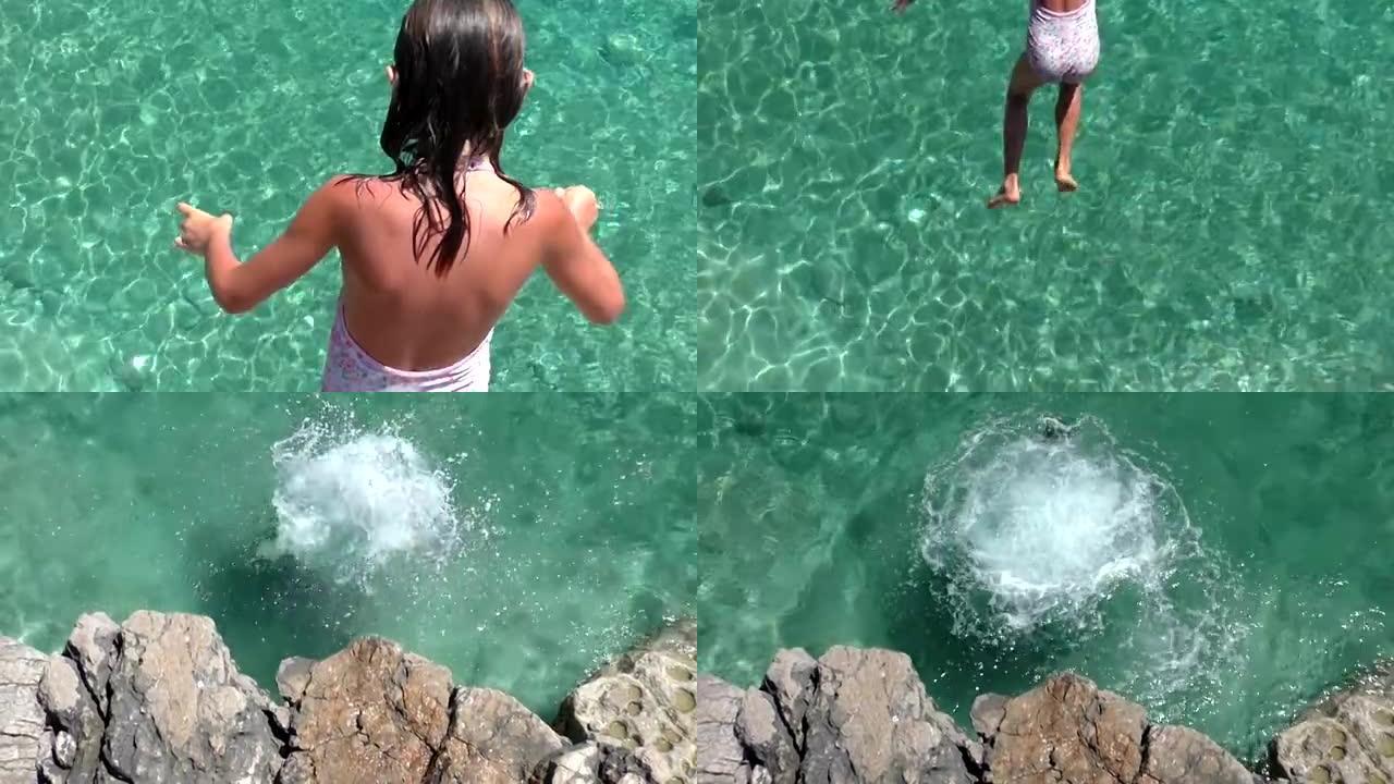 女孩从高高的岩石跳进海里。
