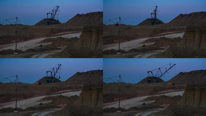 黄昏时分，在背景中使用拖曳挖掘机装载矿石的宽阔镜头。翻斗卡车经过的后视图。铝土矿的猎物。