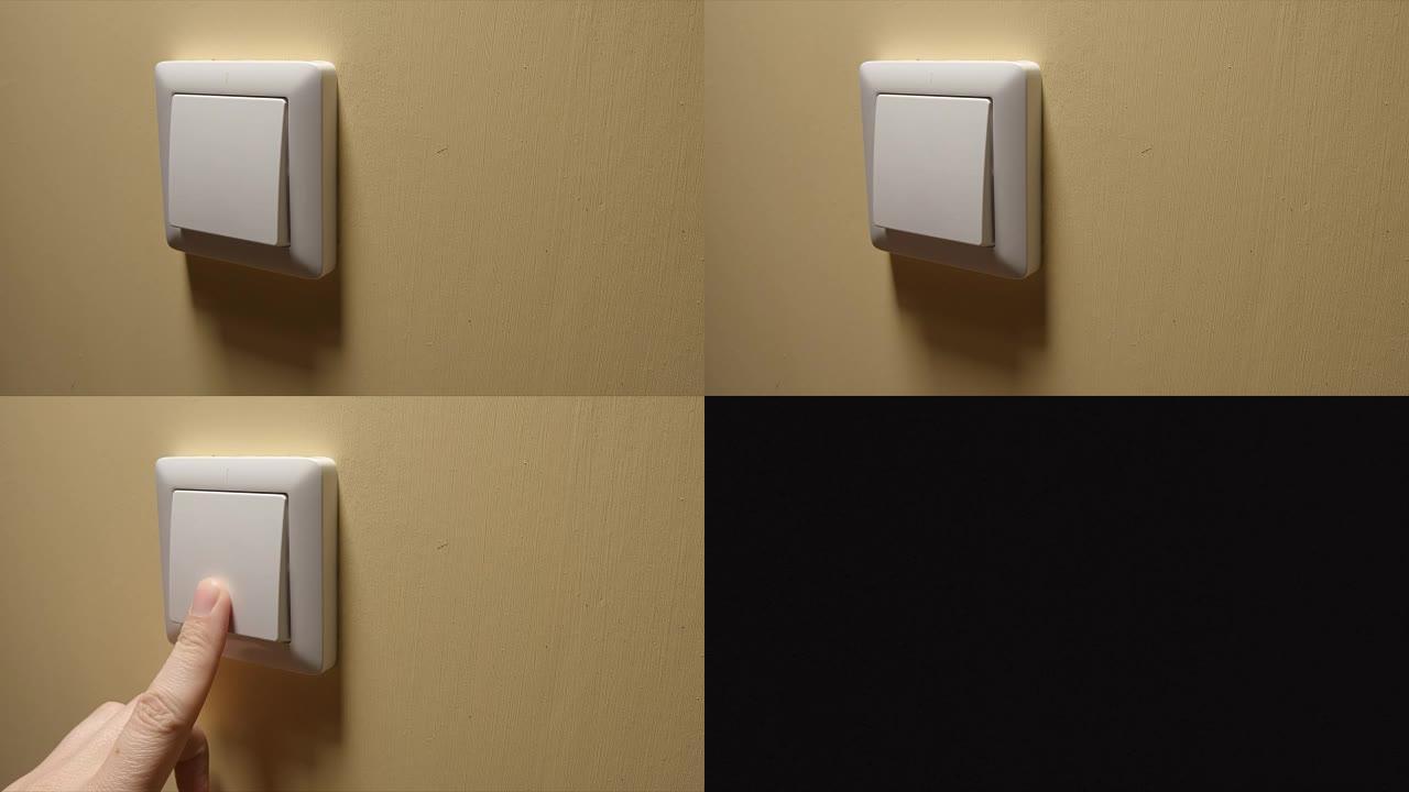 灯熄灭-人手关闭黄色墙壁上的按钮-侧视图