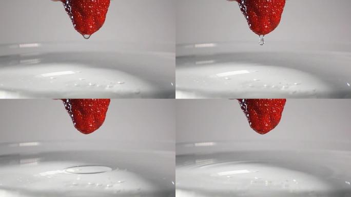 水滴从草莓落到水中