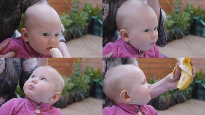 婴儿从母亲的手中吃香蕉