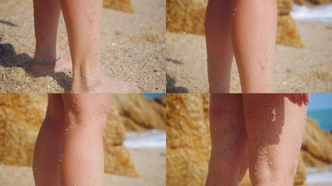 女人的脚戴着手镯在热带海滩上行走，慢动作在沙滩上留下脚印。1920x1080