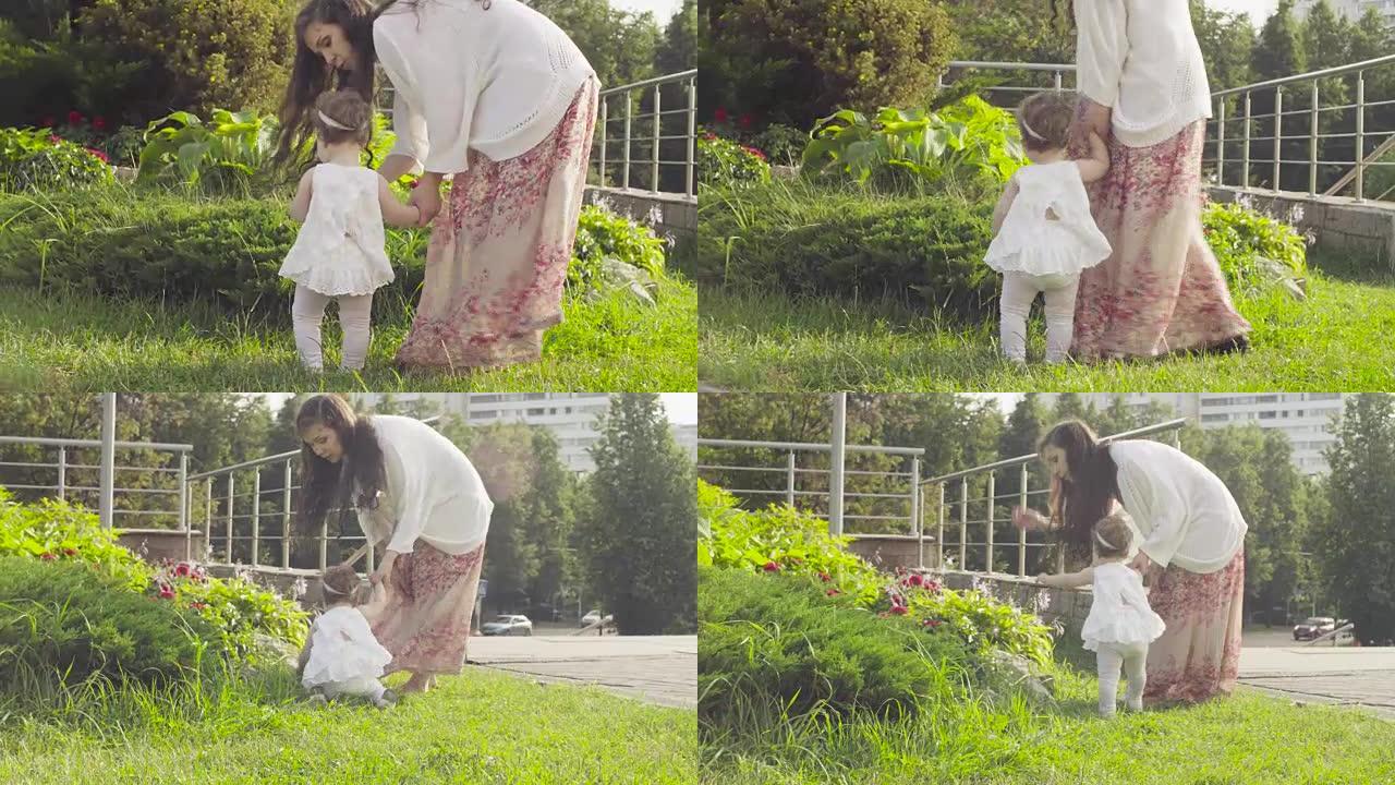 女婴在花坛上看花