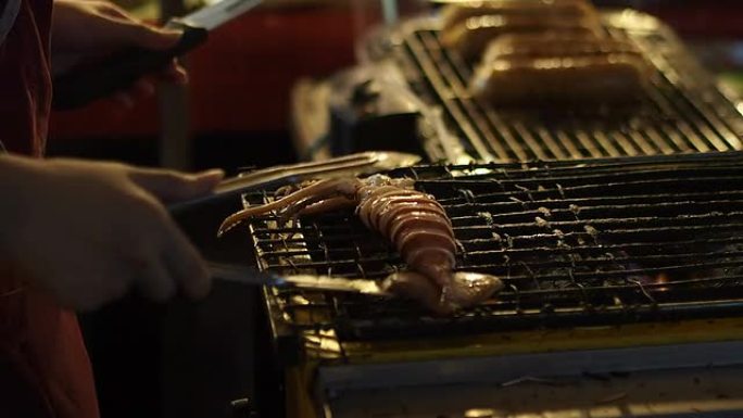 供应商在泰国传统街头食品市场烧烤鱿鱼