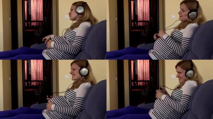 俏皮的孕妇戴着耳机听音乐