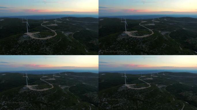 日落时九个用于生产电能的风车的鸟瞰图