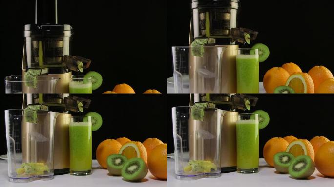 使用咀嚼榨汁机从橙子和猕猴桃中榨出一杯鲜榨果汁