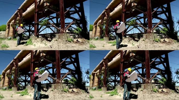 热电站戴着黄色安全帽的工人，配有工程图纸