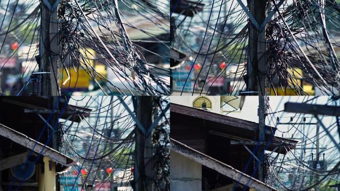 缠结的架空电线束。泰国毛伊岛街道上的电力系统。泰国电线水平盘过载公用事业杆上的电线缠结。慢动作