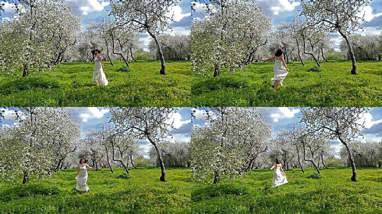 年轻女子在盛开的苹果园里玩得开心