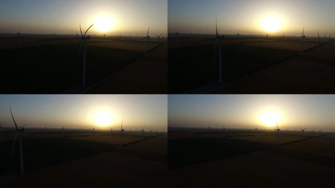 夏天日落时麦田里的风力发电机。轮廓。航空摄影测量