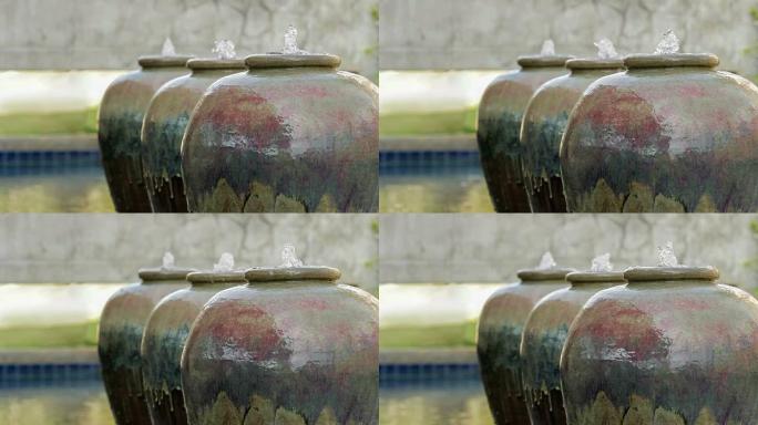 花园中的陶瓷罐喷泉。