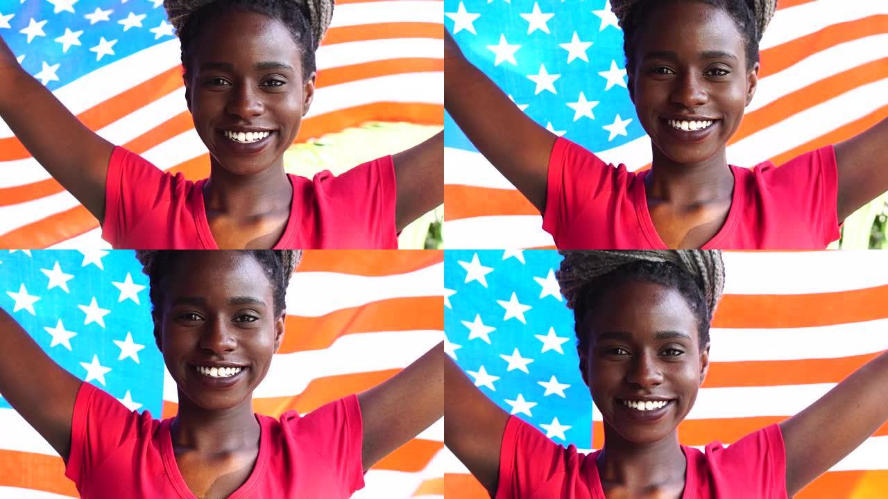 美国年轻黑人妇女举着美国国旗庆祝
