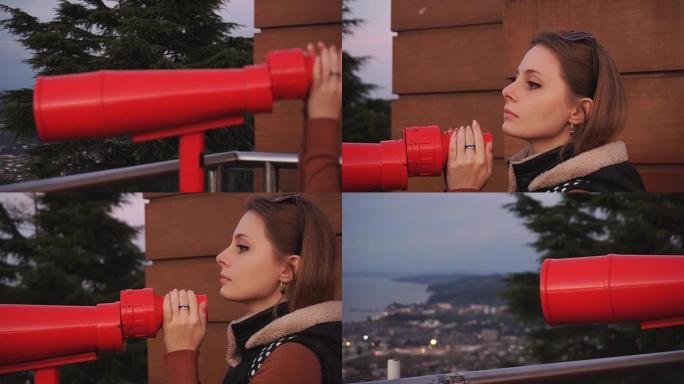 旅行: 年轻的女性游客在日落时通过投币式双筒望远镜看着城市。特写镜头，手持，慢动作60fps