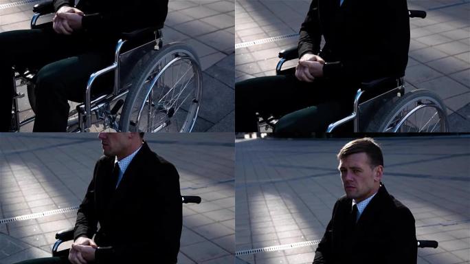 户外轮椅上的悲伤残疾商人