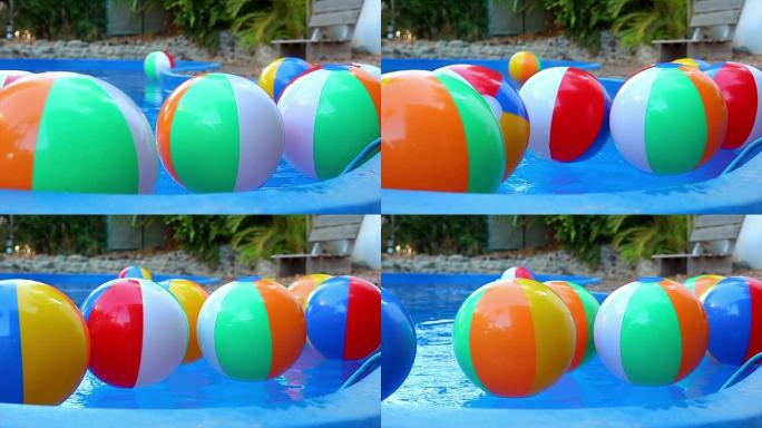 彩色沙滩球以慢动作漂浮在游泳池中
