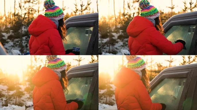 女人从汽车上除雪和冰