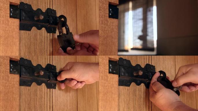用黑色滑动螺栓解锁木板门上的挂锁
