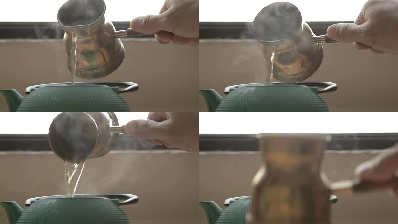 传统的咖啡壶将热水倒入绿茶箱