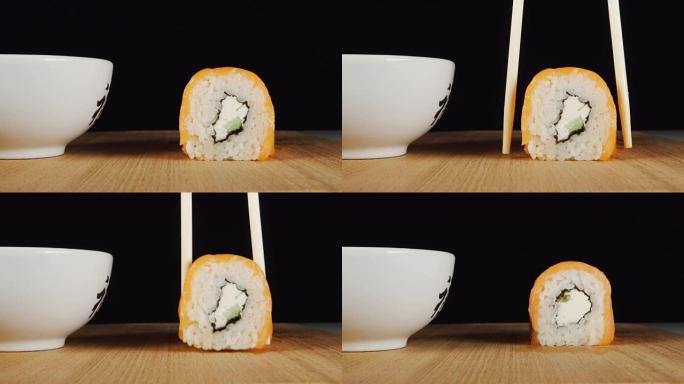 人类的手用筷子拿寿司
