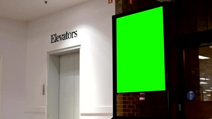 电梯旁边的绿色广告广告牌