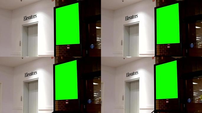 电梯旁边的绿色广告广告牌