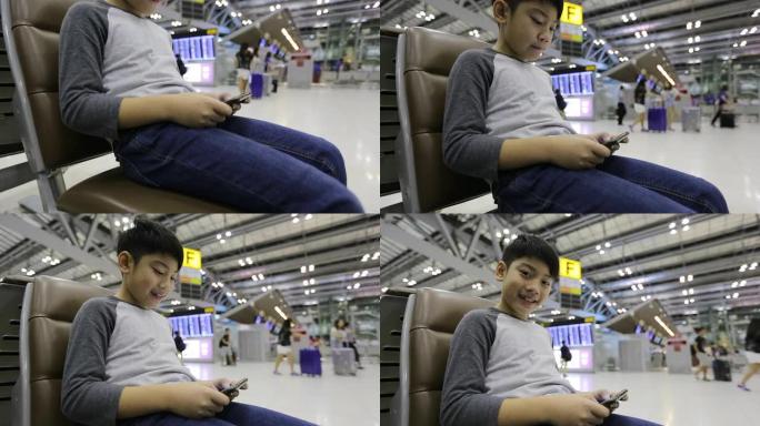 亚洲男孩在智能手机上玩游戏