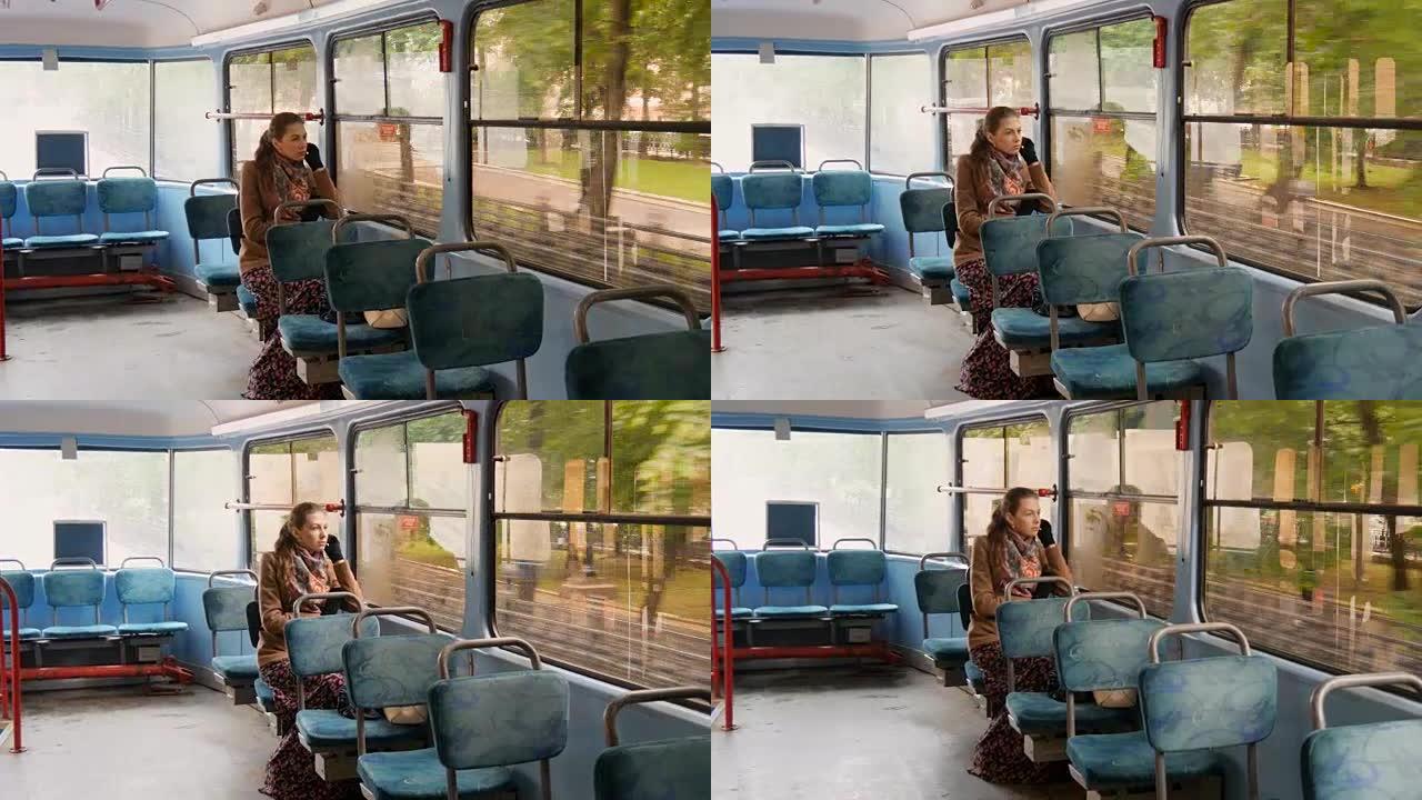 一个有着悲伤眼神的美丽女孩坐在电车上。