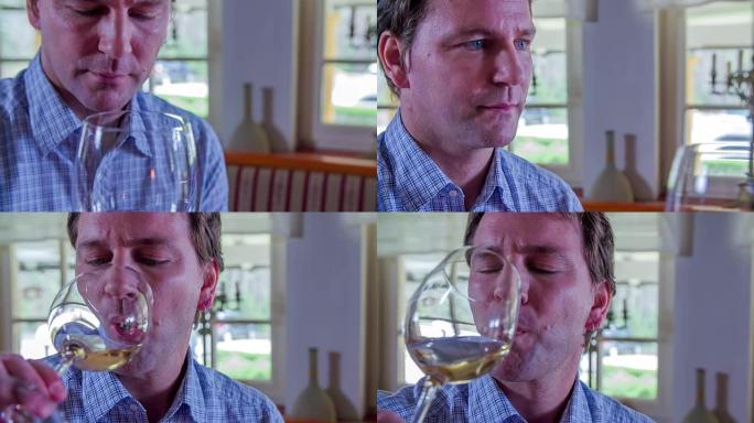 男人在杯子里闻到葡萄酒的味道