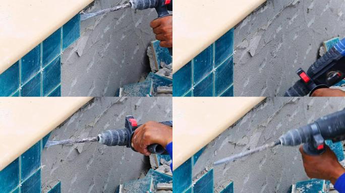 工人用冲击钻修理瓷砖墙