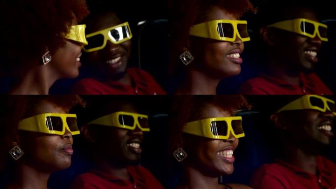 快乐的非洲裔美国夫妇在剧院观看3D电影。特写