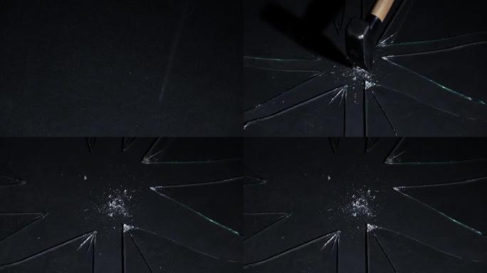 在玻璃上用锤子敲打碎片的冲击飞散。慢动作