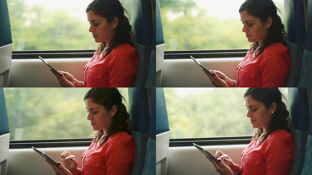 在行驶中的火车内使用平板电脑的女人