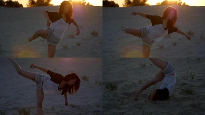 日落时分，美女职业舞者在海滩上慢动作摆姿势