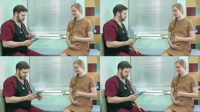 医生与孕妇交谈并看着数字平板电脑