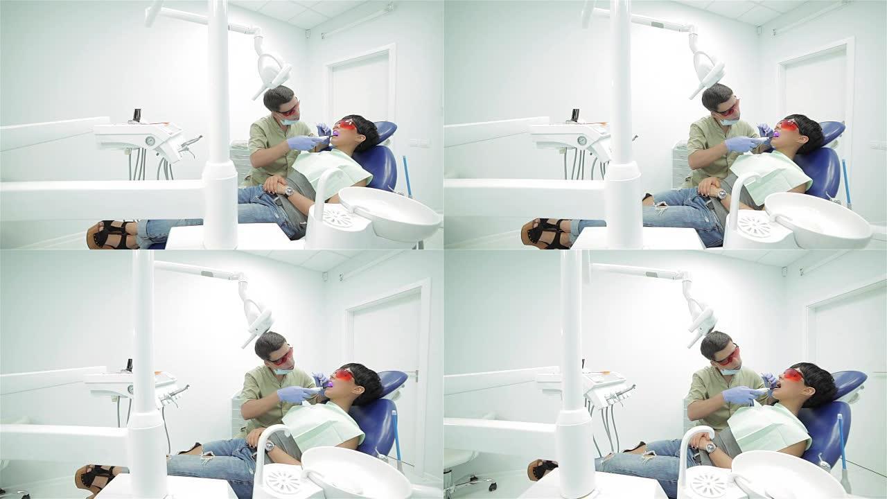 牙医将紫外线光聚合物密封固定在其上