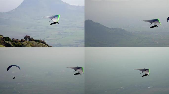 迷雾山谷上空的滑翔伞和滑翔伞