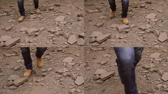 穿着登山靴的人沿着石头走，特写镜头。