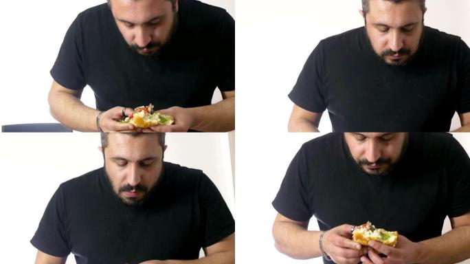 一个饥饿的人正在吞食一个汉堡包