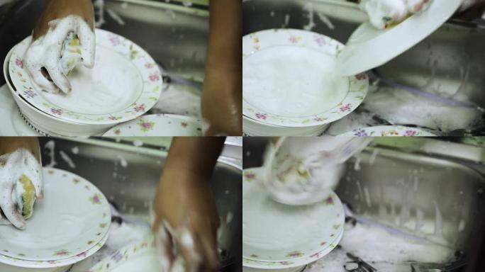 女性洗脏盘子