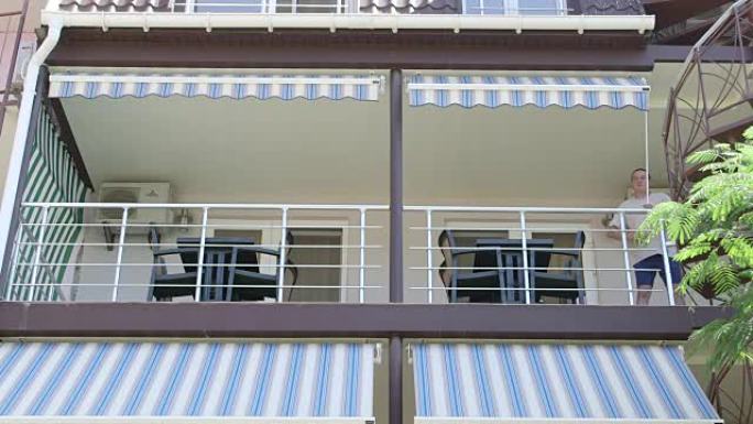 夏季酒店男子的遮阳阳台在阳光明媚的日子里展开可伸缩遮阳篷