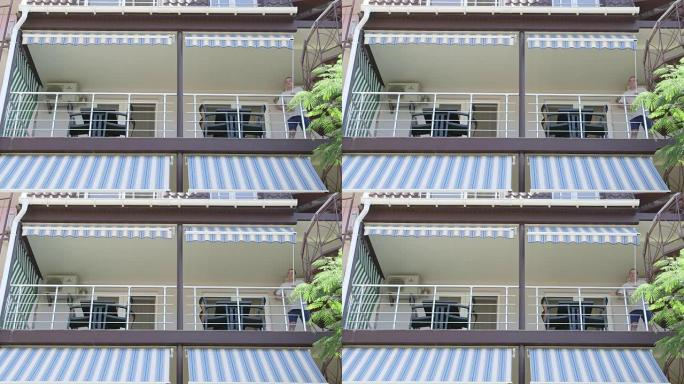 夏季酒店男子的遮阳阳台在阳光明媚的日子里展开可伸缩遮阳篷