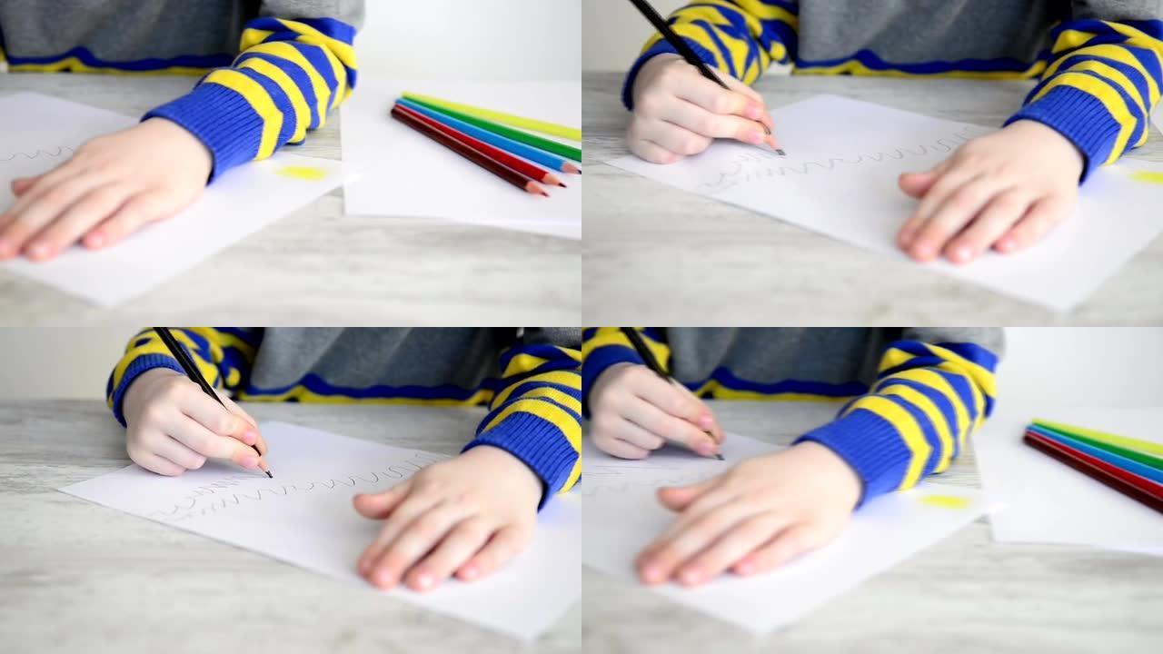 男孩用黑色铅笔在纸上画画