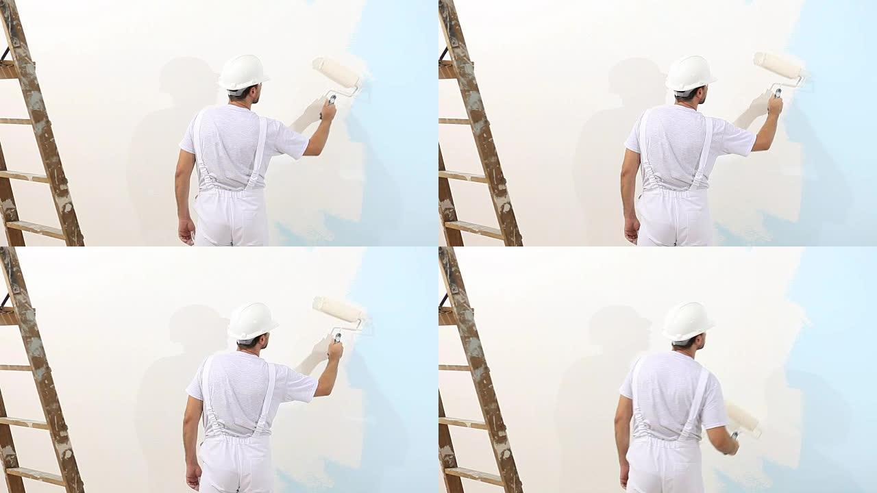 工作中的画家，带滚筒画墙，画家屋概念