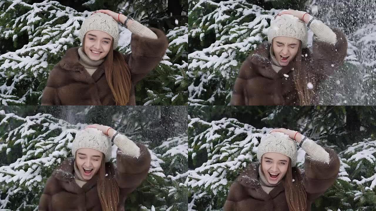 一团雪落在站在树附近的女孩身上。慢动作