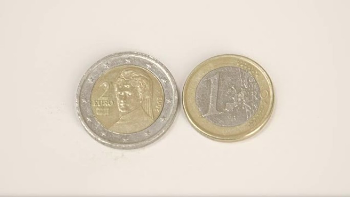 桌子上有一枚2枚澳大利亚欧元硬币和1枚奥地利欧元硬币