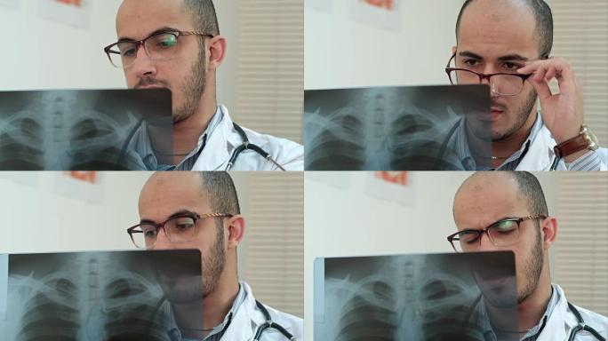 戴眼镜的年轻男医生仔细分析x射线图像