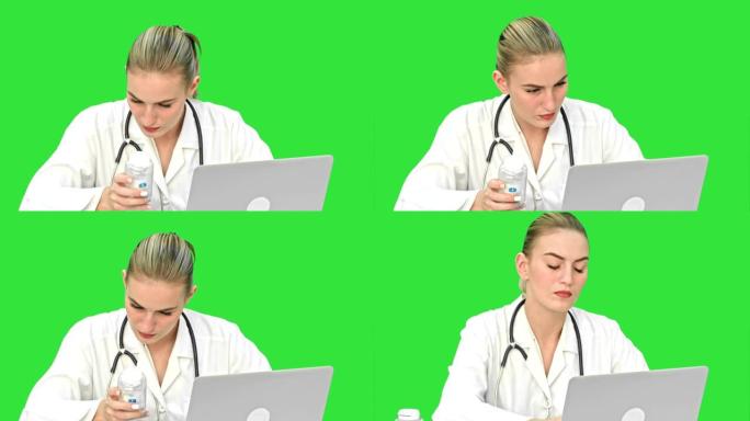 年轻的女医生在笔记本电脑上打字，试图在互联网上的绿屏上找到药丸手册，色键